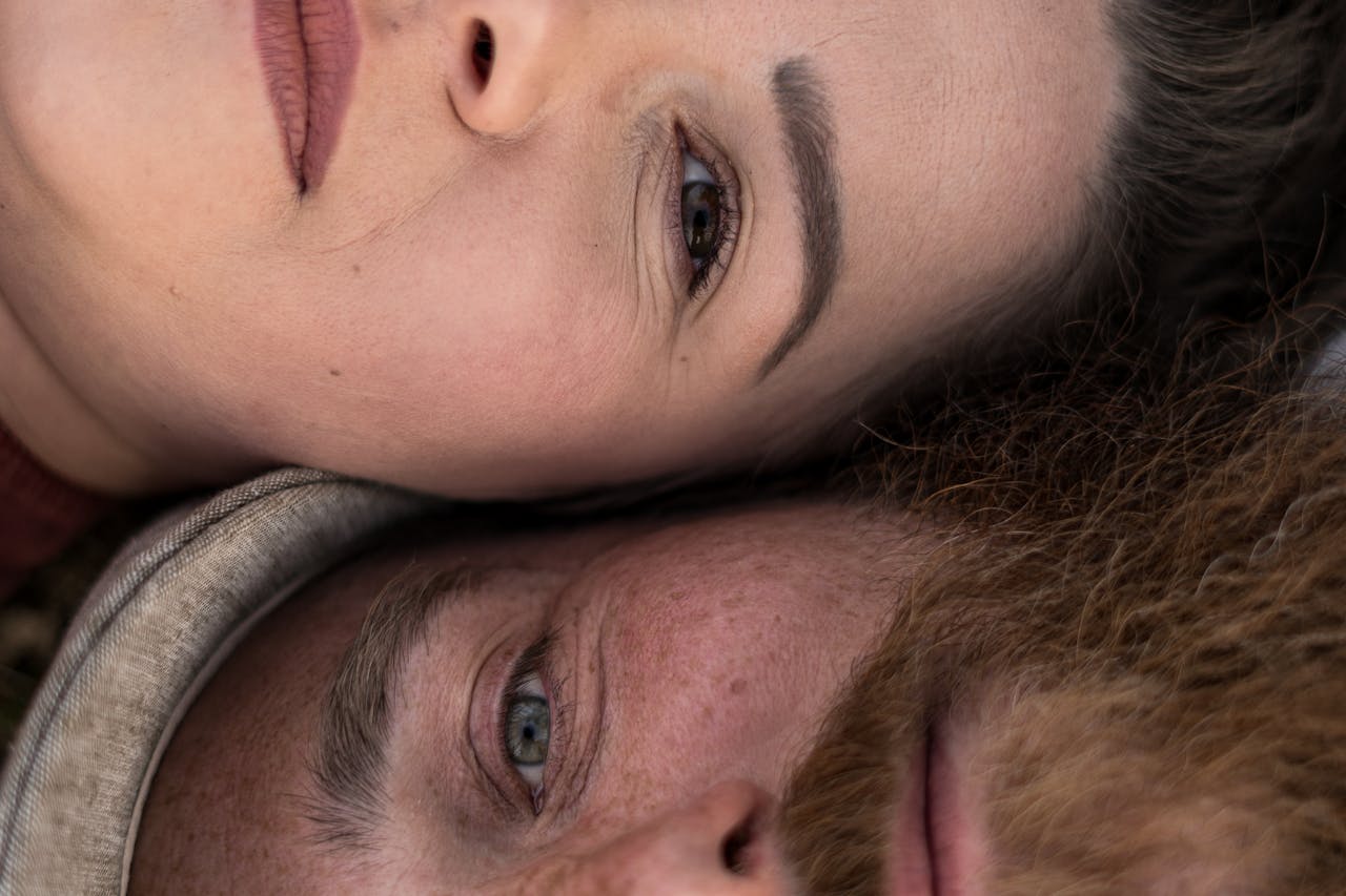 services-03 A close-up of a couple lying together, expressing love and relaxation in an outdoor setting.